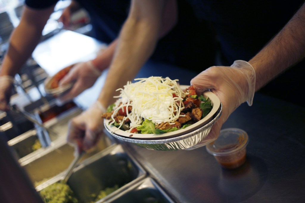 An employee prepares a burrito bowl at a Chipotle Mexican Grill Inc. restaurant in Louisville, Kentucky, USA, on Saturday, February. 2, 2019. 